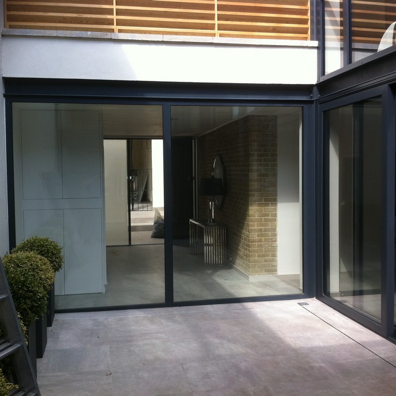 Floor-to-ceiling sliding doors opening to courtyard in Buckingham