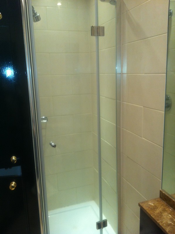 Frameless glass shower enclosure with chrome fittings in Buckingham