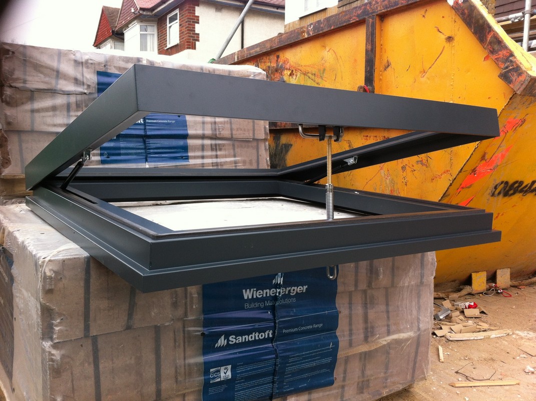 Opening flat roof skylight in anthracite grey installed in Buckingham