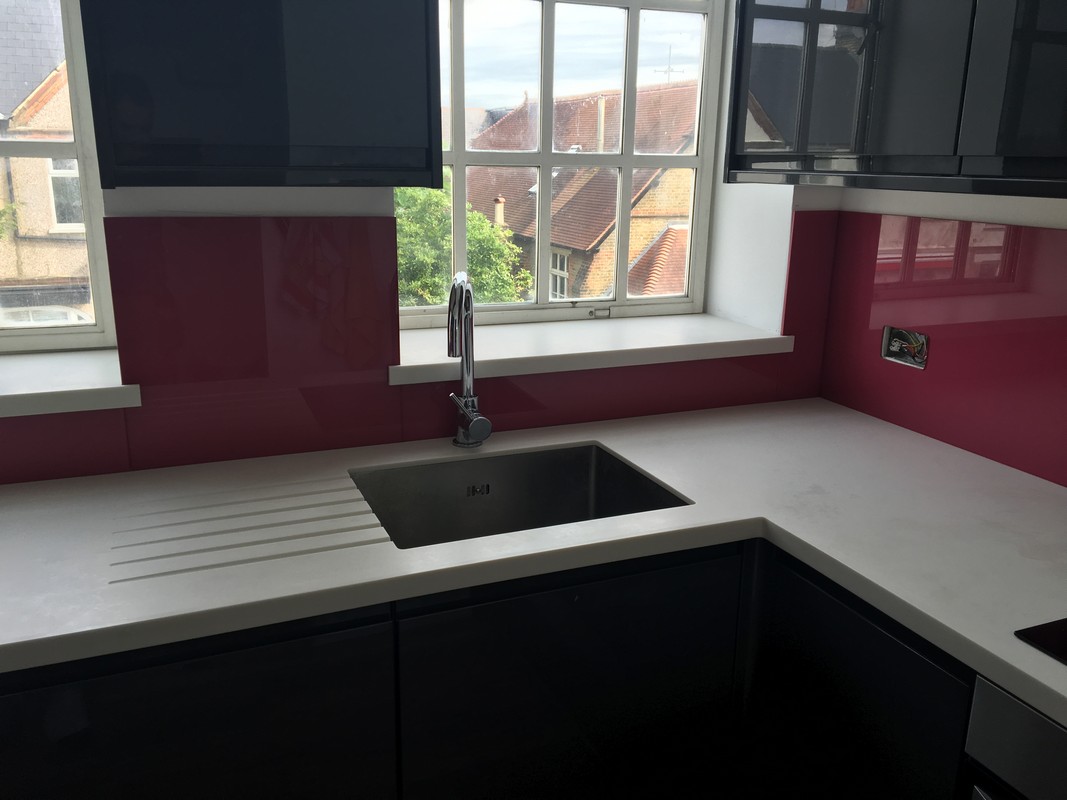 Deep plum coloured glass splashback in modern Buckingham kitchen